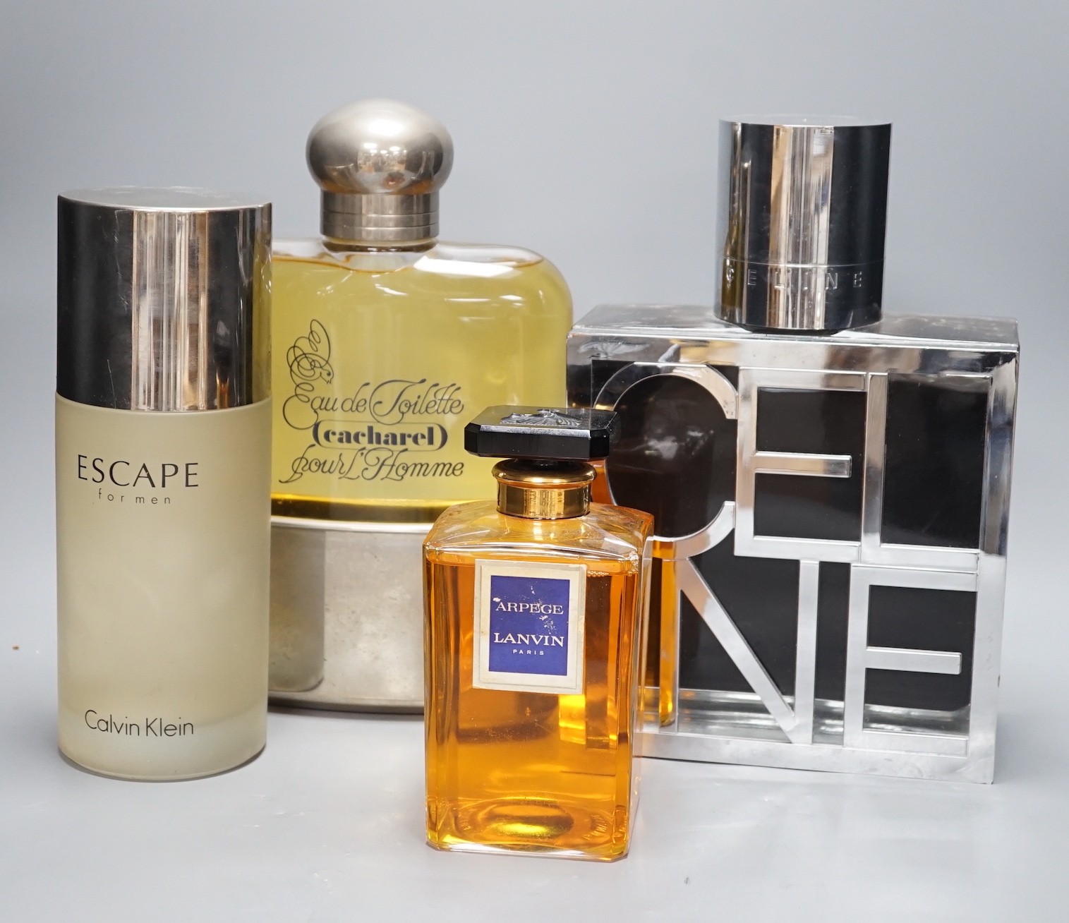 Oversized advertising perfume display bottles including Celine, Cacharel pour Homme, Arpege Lavin and a Calvin Klein perfume bottle (4), tallest Celina 33 cms high